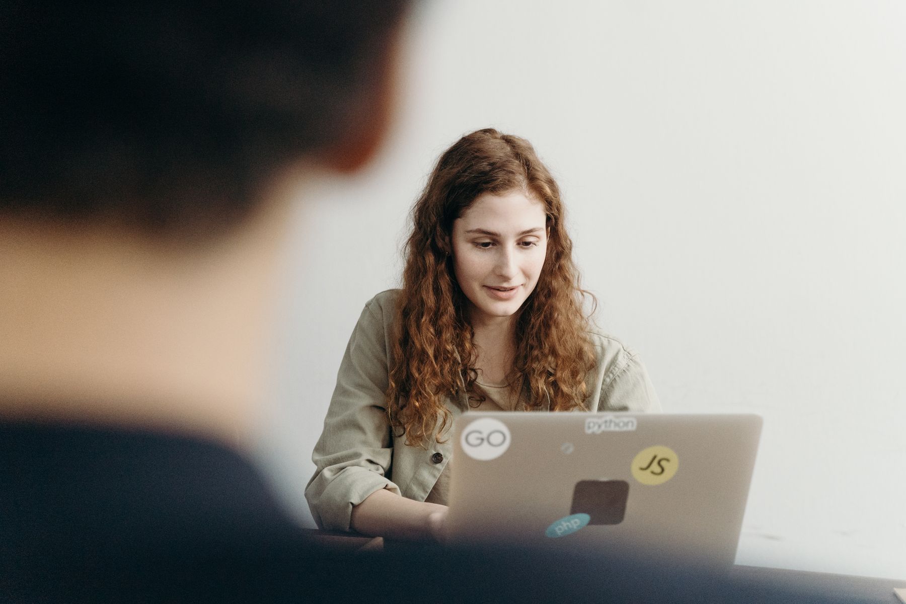 A young professional presenting her work from a laptop